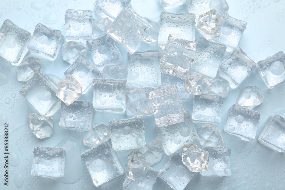 Crystal clear ice cubes on light blue background, flat lay Crystal clear ice cubes on light blue background, flat lay