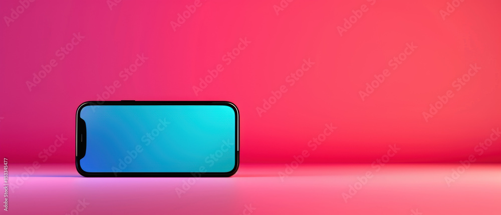 Fototapeta premium A phone is sitting on a pink background