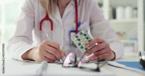 Woman doctor prescribes course of recovery pills to patient