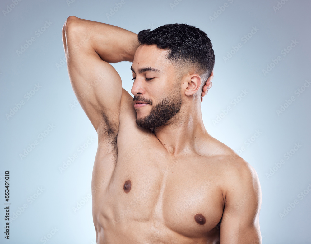 Smile, man and smelling armpit for hygiene with skin health and deodorant fragrance for self care in studio. Happy male person, underarm and check sweat for clean body and perfume by gray background Smile, man and smelling armpit for hygiene with skin health and deodorant fragrance for self care in studio. Happy male person, underarm and check sweat for clean body and perfume by gray background