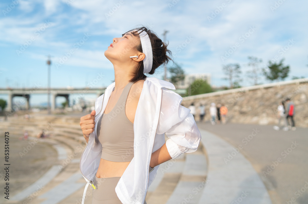 Fototapeta premium a woman who works out at a riverside park
