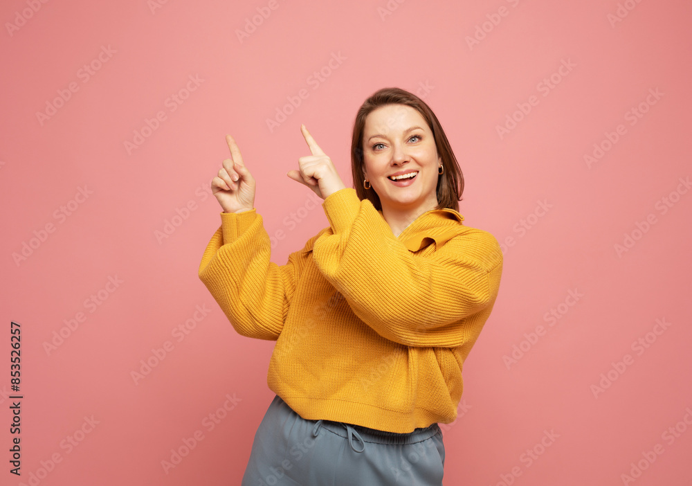 Woman having idea raising finger up isolated on pink color background Woman having idea raising finger up isolated on pink color background