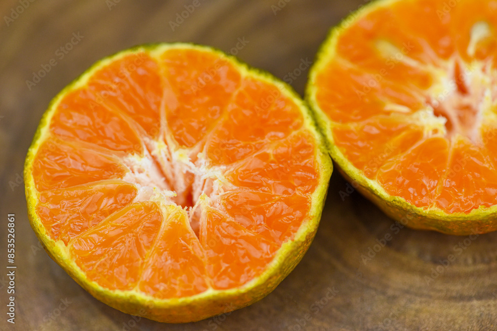 close up view of orange slice on wood table . fresh orange fruit . Orange half clipping path close up view of orange slice on wood table . fresh orange fruit . Orange half clipping path