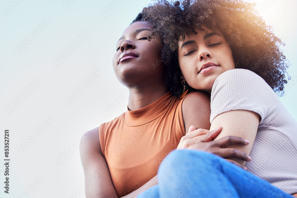 Fototapeta premium Gay couple, relax and embrace with hug for LGBTQ, pride or love on outdoor freedom together. Interracial, young female person or calm lesbians with smile for romance, care or bonding with blue sky
