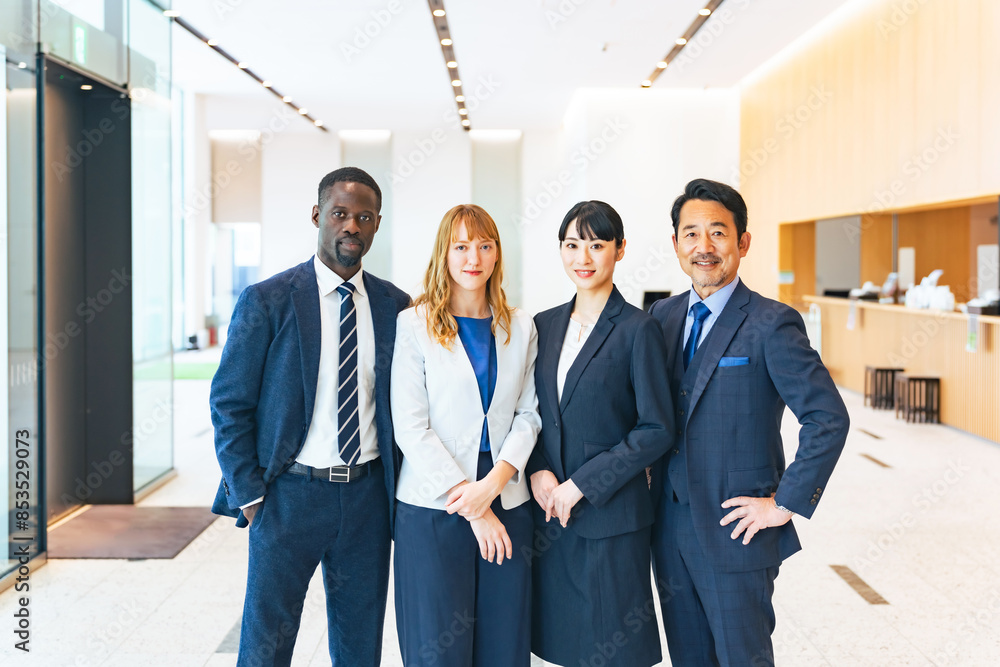 A group of multinational business people standing in a lobby A group of multinational business people standing in a lobby