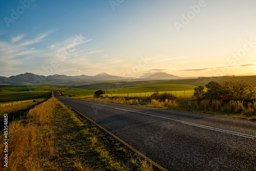 The R326 paved road near Stanforn with the  Kleinrivier Mountains in the background. Western Cape. South Africa