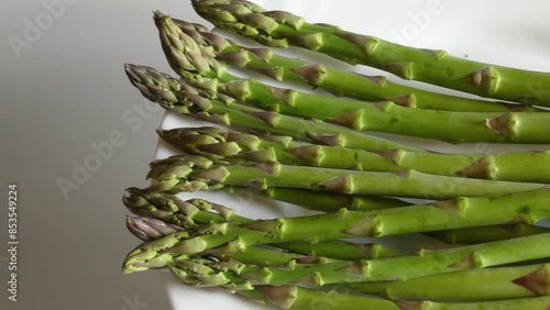 Rotating Green Asparagus on White Dish