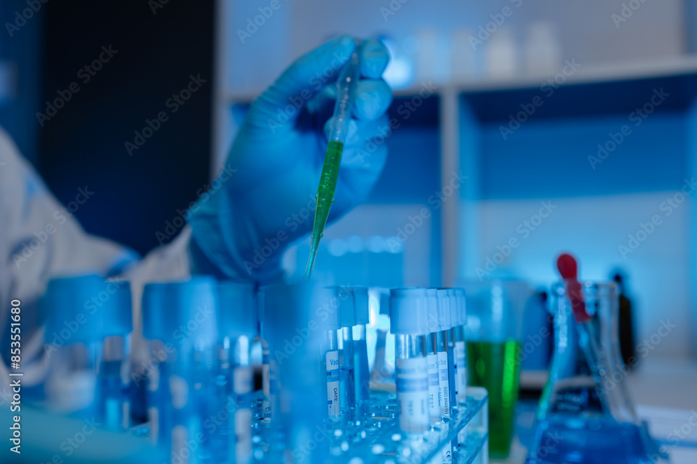 A scientist uses laboratory equipment for a research experiment, test tube is essential for chemists to use in experiments, scientific researchers must concentrate on testing samples in the lab A scientist uses laboratory equipment for a research experiment, test tube is essential for chemists to use in experiments, scientific researchers must concentrate on testing samples in the lab