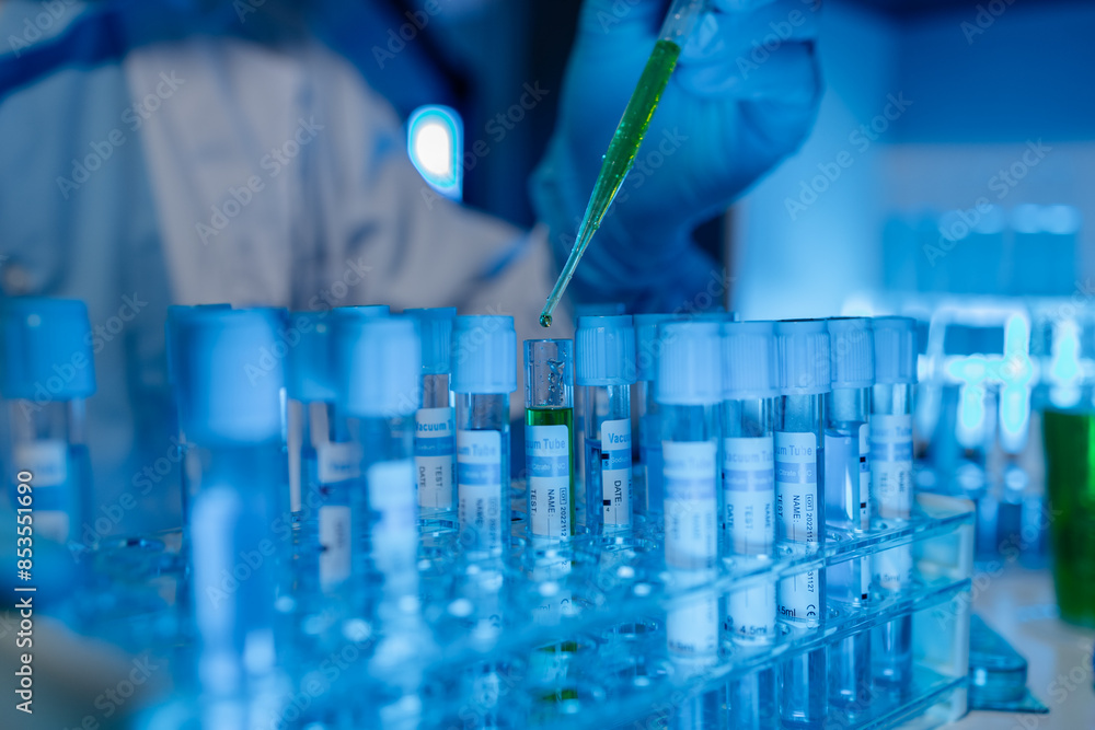 A scientist uses laboratory equipment for a research experiment, test tube is essential for chemists to use in experiments, scientific researchers must concentrate on testing samples in the lab A scientist uses laboratory equipment for a research experiment, test tube is essential for chemists to use in experiments, scientific researchers must concentrate on testing samples in the lab