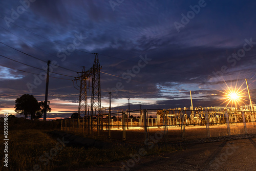 Infrastructure of electrical substation distributing renewable energy at night. A powerful electrical Substation High-voltage electric current.