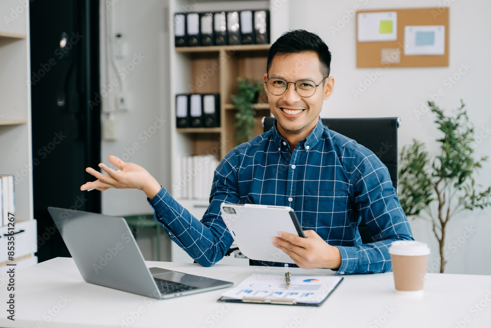 Fototapeta premium Businessman executive manager looking at laptop watching online webinar training or having virtual meeting video conference doing market research working