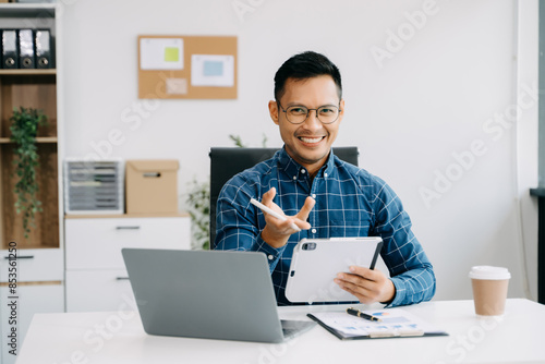 Businessman executive manager looking at laptop watching online webinar training or having virtual meeting video conference doing market research working