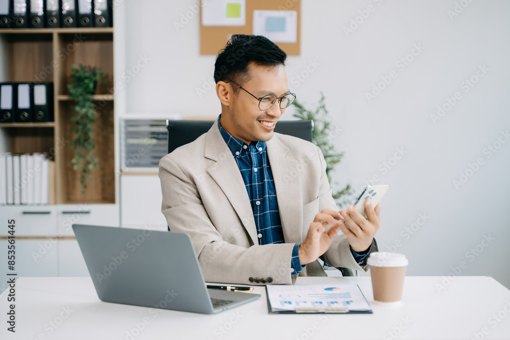 Fototapeta premium Businessman executive manager looking at laptop watching online webinar training or having virtual meeting video conference doing market research working