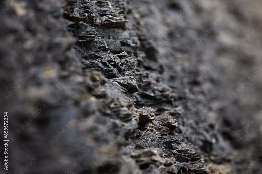 Close-up of dark textured cliff rock Close-up of dark textured cliff rock