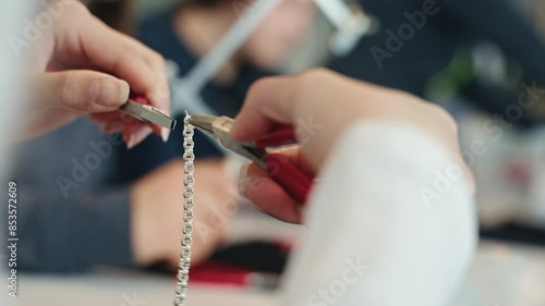 Jewelry atelier fixing silver bracelet, close up view