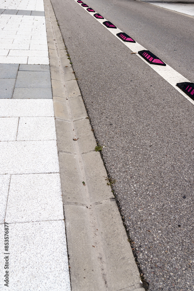 Empty bike lane with white restrictive markings and red light signals on a city street Empty bike lane with white restrictive markings and red light signals on a city street
