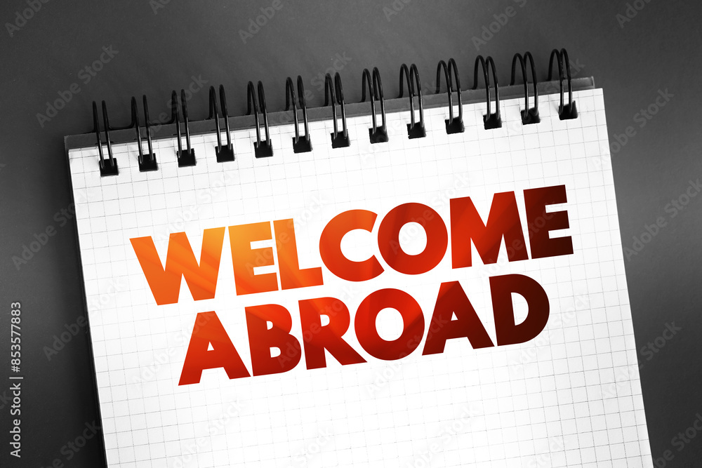 Fototapeta premium Welcome Abroad - greeting given to new employee upon joining a company, text on notepad concept background
