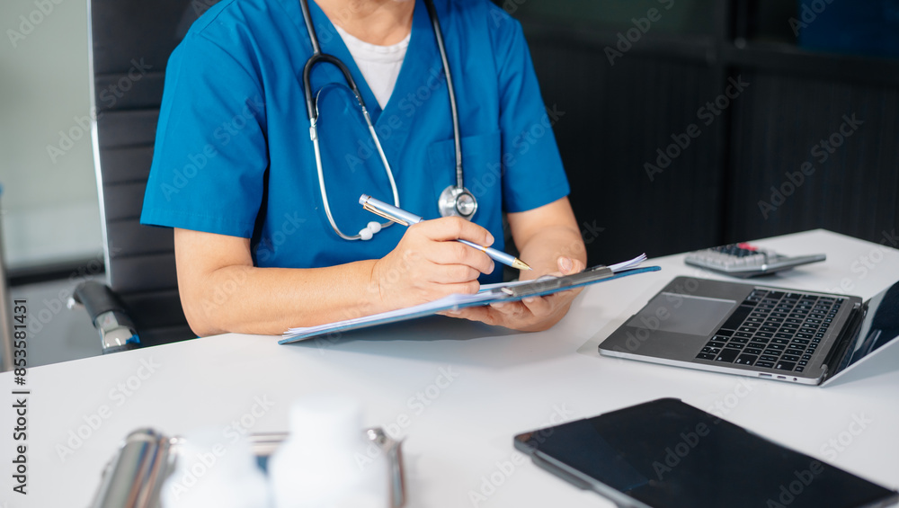 Beautiful physician doctor sit on table in office hospital. Attractive therapist female practitioner pharmacist smile and use tablet Beautiful physician doctor sit on table in office hospital. Attractive therapist female practitioner pharmacist smile and use tablet
