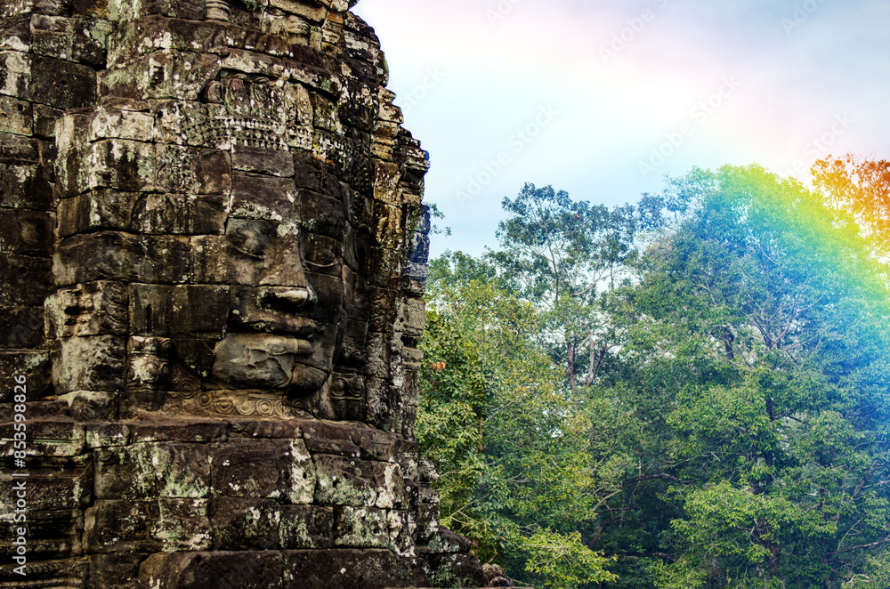 Fototapeta premium The bayon temple smiling stone faces showing on a sunny day in angkor thom, siem reap, cambodia