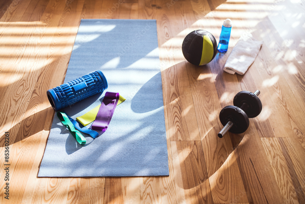 High angle view of fitness equipment on wooden floor. Workout at home. High angle view of fitness equipment on wooden floor. Workout at home.
