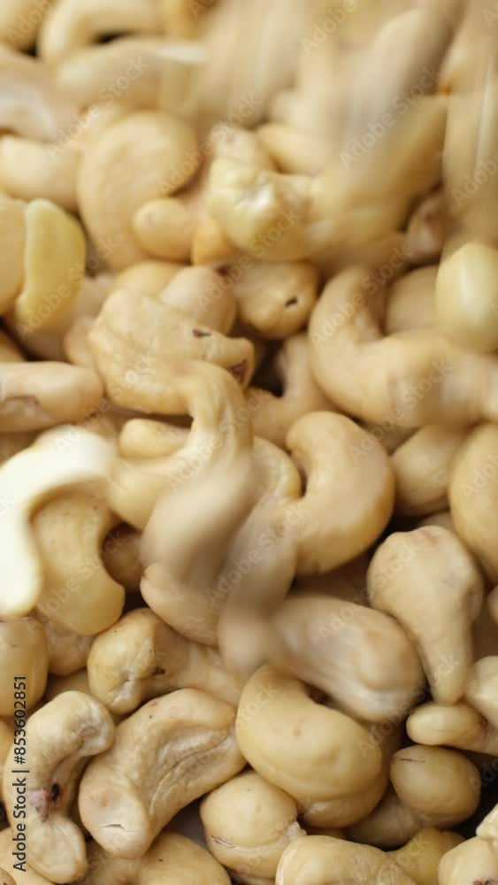 Cashew nuts falling down in plate, top view. Healthy Food concept Cashew nuts falling down in plate, top view. Healthy Food concept