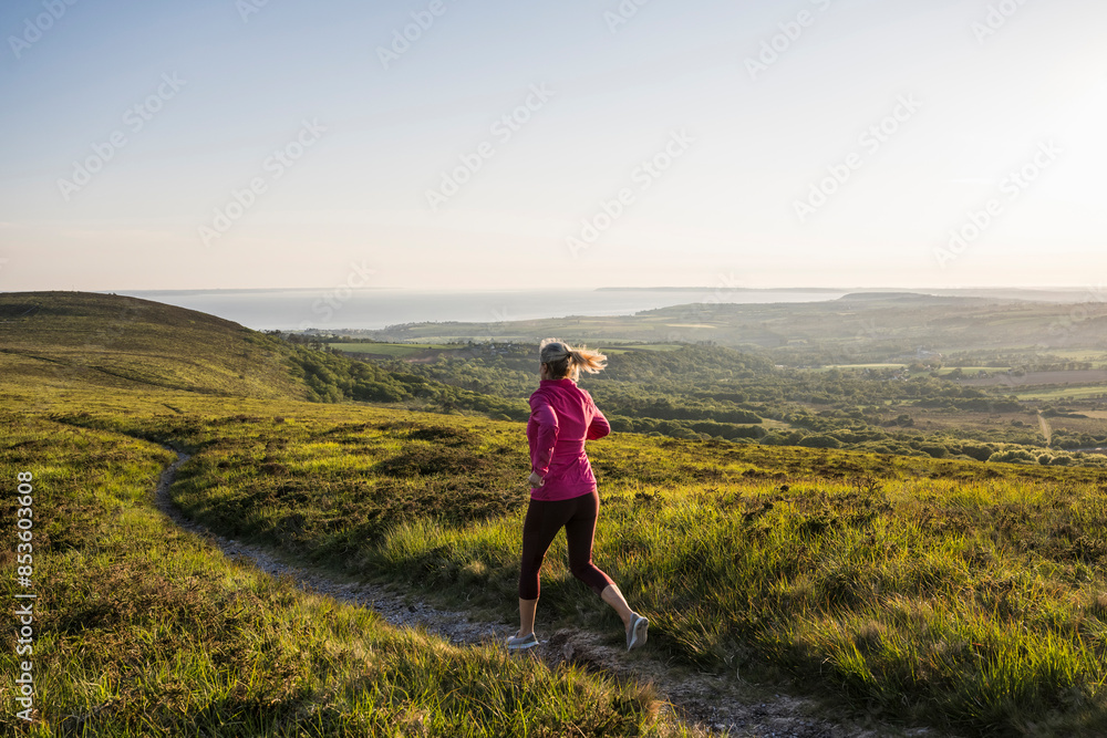 Active woman running on mountain Active woman running on mountain