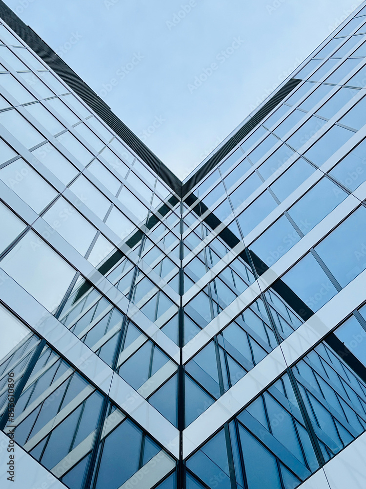 Obraz premium Low angle view of modern office windows skyscraper in urban abstract, geometric and minimalist stylistics