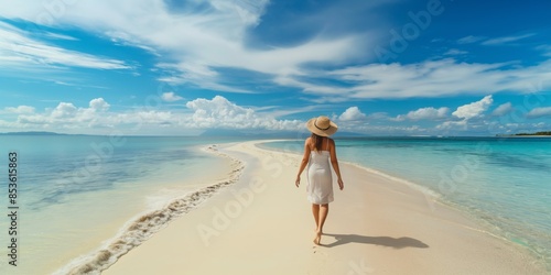 Fototapeta Naklejka Na Ścianę i Meble -  Elegant woman in hat walking tropical beach, enjoying summer holiday.