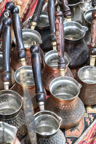 Hammered bronze pot with wooden handle, used to prepare Turkish coffee.