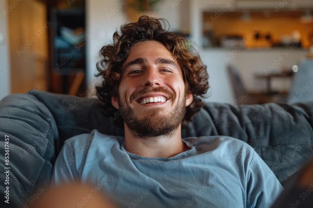A happy person sitting on a sofa, perfect for use in lifestyle or personal images A happy person sitting on a sofa, perfect for use in lifestyle or personal images