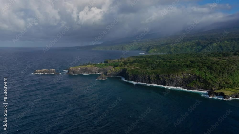 Flying over rocky cliff and pacific ocean off north coast of Maui, Hawaii Flying over rocky cliff and pacific ocean off north coast of Maui, Hawaii