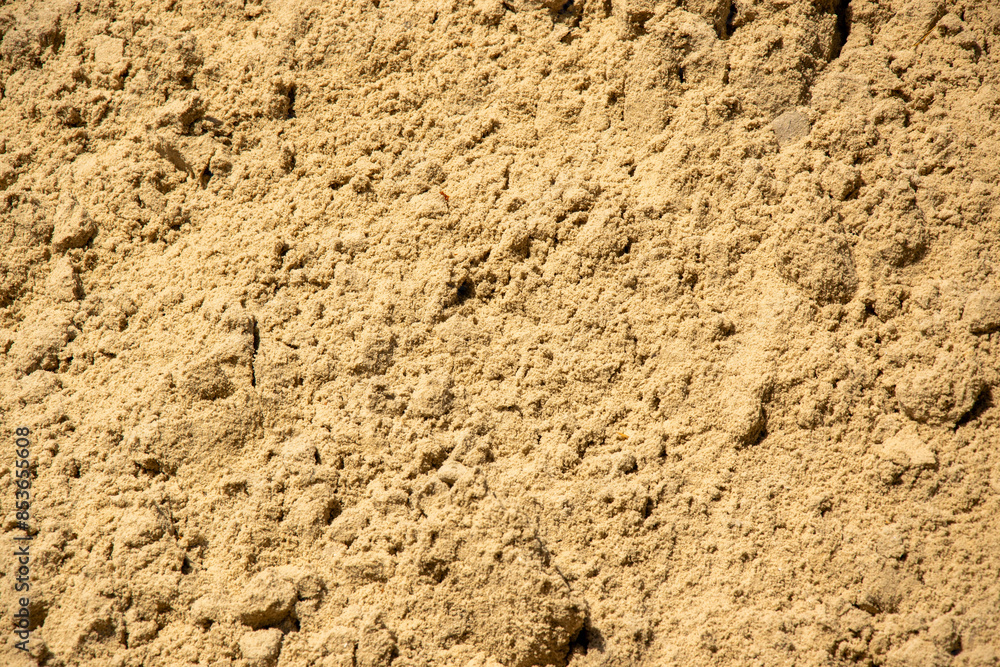 A close-up image of fine sand, showcasing its texture and color A close-up image of fine sand, showcasing its texture and color