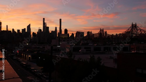 New York City Manhattan skyline cityscape. Rooftop in Queens, Midtown buildings, Queensboro Bridge. Sunset pink purple sky from roof in Long Island. Skyscrapers silhouette, high-rise architecture, NYC photo