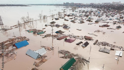 Major flooding. Damaged houses in the flood. The houses were washed away by the current of the water. A city destroyed by a flood. A natural disaster, an emergency. An environmental disaster. Damage.