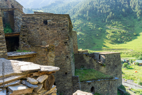 Living quarters of the medieval village of Shatili. Forest, mountains and camping in the background photo