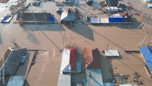 The city is in the water. Damaged houses in the flood. The houses were washed away by the current of the water. A city destroyed by a flood. A natural disaster, an emergency. An environmental disaster