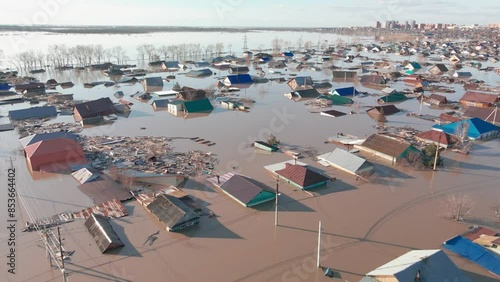 The city is in the water. Damaged houses in the flood. The houses were washed away by the current of the water. A city destroyed by a flood. A natural disaster, an emergency. An environmental disaster