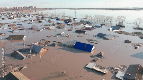 Major flooding. Damaged houses in the flood. The houses were washed away by the current of the water. A city destroyed by a flood. A natural disaster, an emergency. An environmental disaster. Damage.