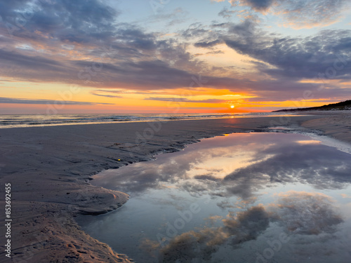 Fototapeta Naklejka Na Ścianę i Meble -  sunrise in the morning over the baltic sea with wave on the sand beach