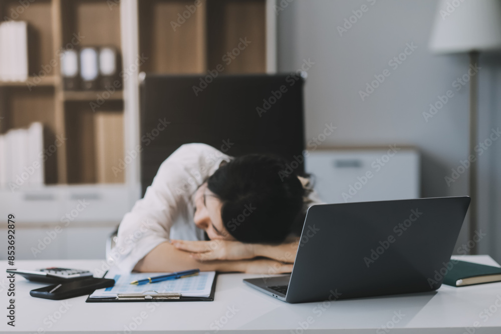Asian women are stressed while working on laptop, Tired asian businesswoman with headache at office, feeling sick at work, copy space Asian women are stressed while working on laptop, Tired asian businesswoman with headache at office, feeling sick at work, copy space