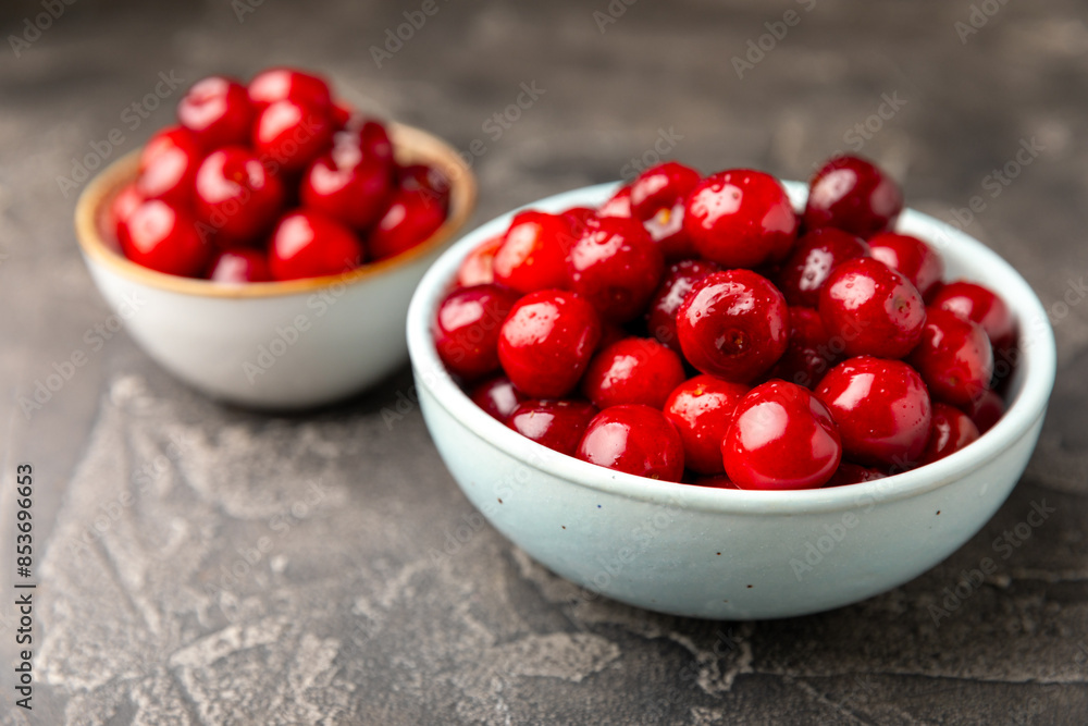 Cherries. Fresh ripe cherries with leaves on a textured wooden background. Fresh sweet organic cherry pile. Berries and fruits. Vegan. Healthy eating. Place for text. Copy space Cherries. Fresh ripe cherries with leaves on a textured wooden background. Fresh sweet organic cherry pile. Berries and fruits. Vegan. Healthy eating. Place for text. Copy space