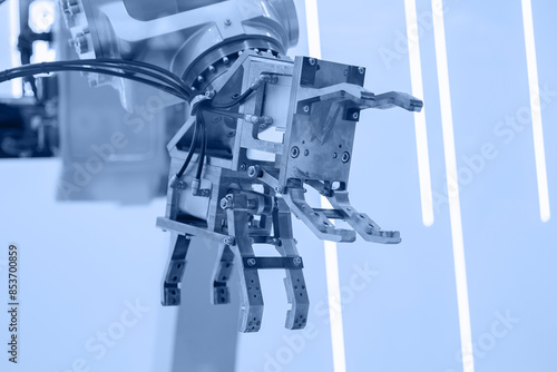 CNC AI robot arm with gripper in factory, robotics hand moving pipes along conveyor belt