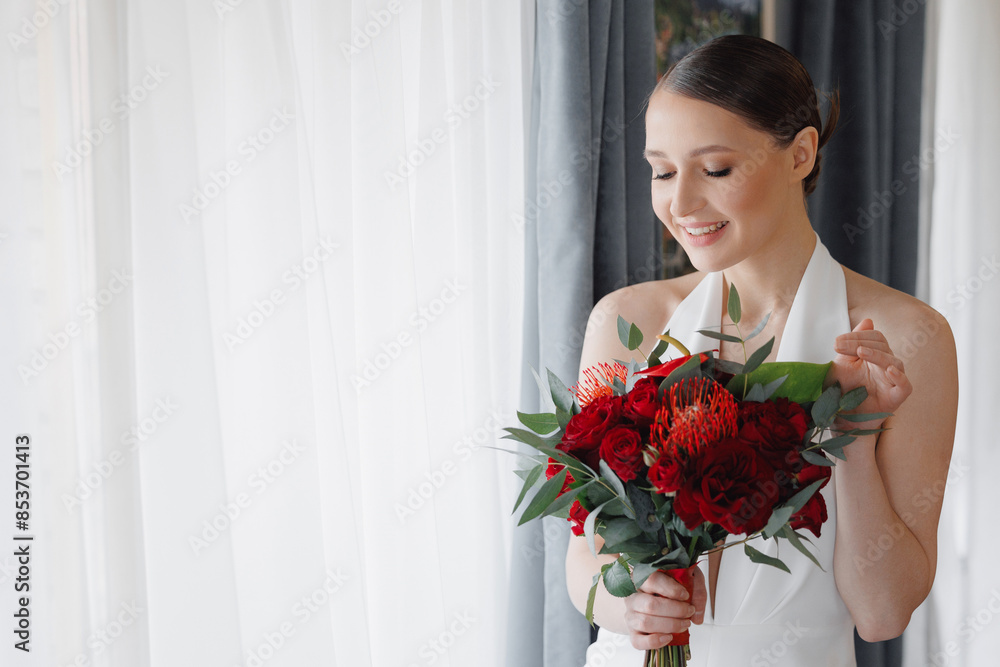 Portrait bride young woman in white dress with pearl necklace holding modern lush red wedding bouquet Portrait bride young woman in white dress with pearl necklace holding modern lush red wedding bouquet