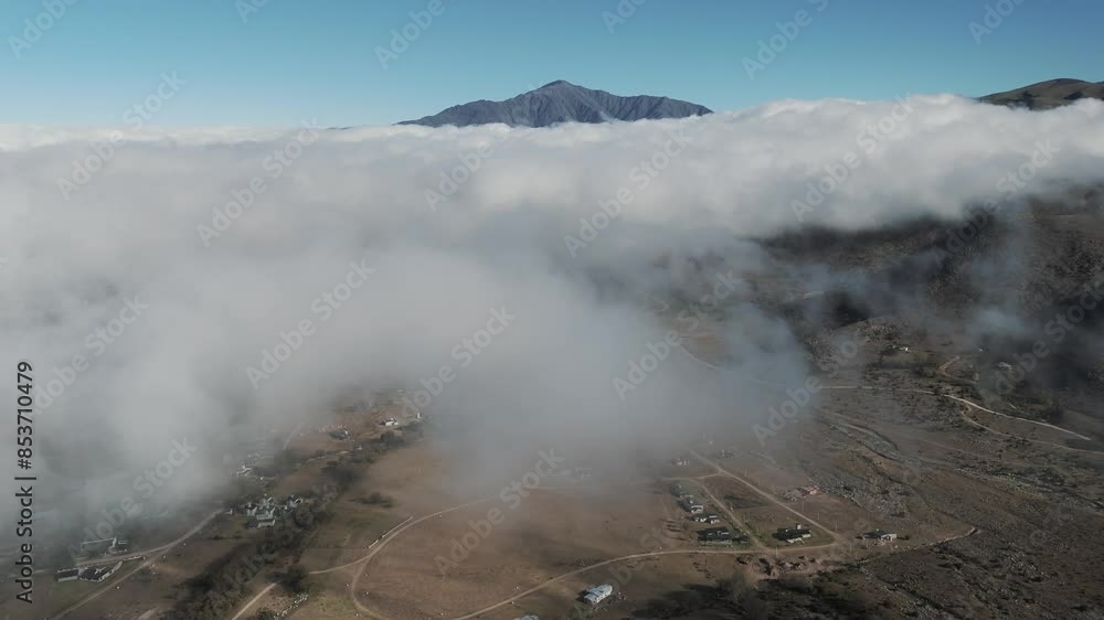 Aerial drone view passing through clouds over the town of Tafí del Valle in Tucumán, Argentina. Climate change. Drone 4k Aerial drone view passing through clouds over the town of Tafí del Valle in Tucumán, Argentina. Climate change. Drone 4k