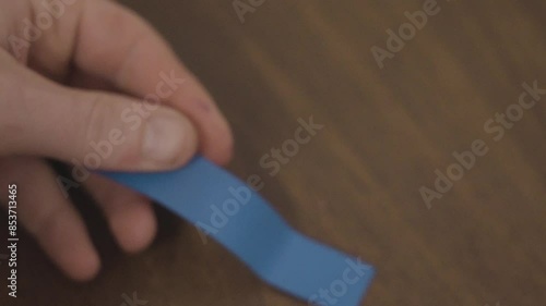 Handling a strip of electric tape in slow motion. photo