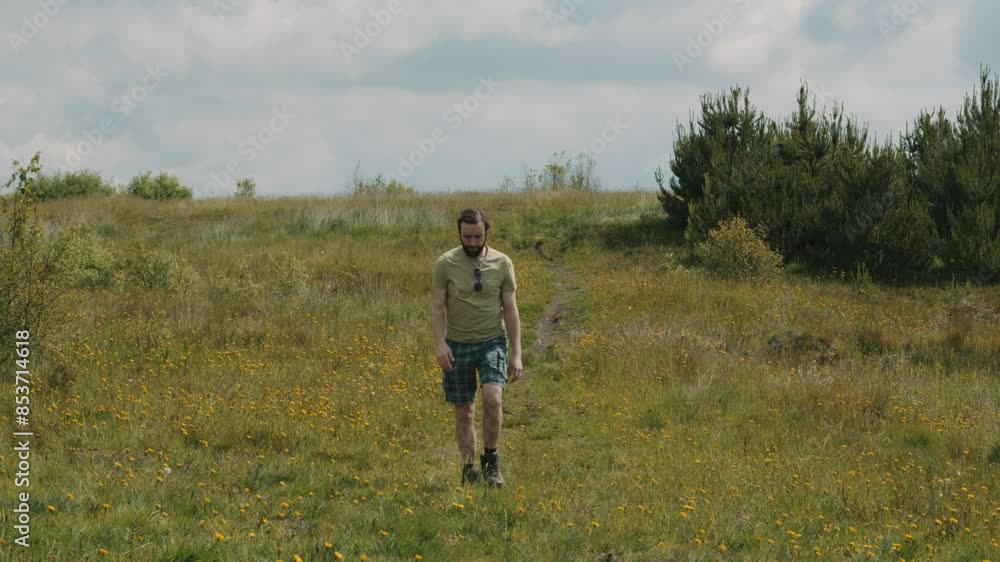 Man Walking Along Path in Nature on Hot Day with T-Shirt and Shorts Man Walking Along Path in Nature on Hot Day with T-Shirt and Shorts