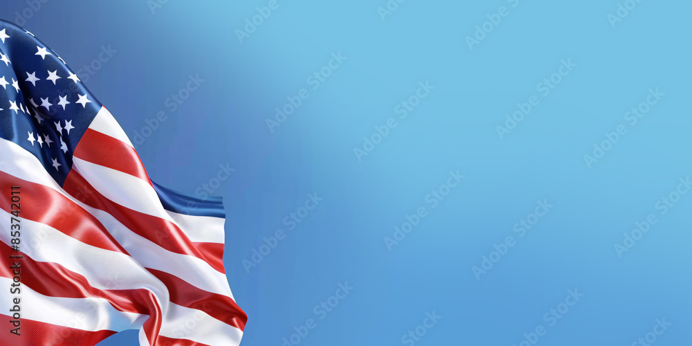 Obraz premium An American flag with red and white stripes waves proudly against a clear blue sky