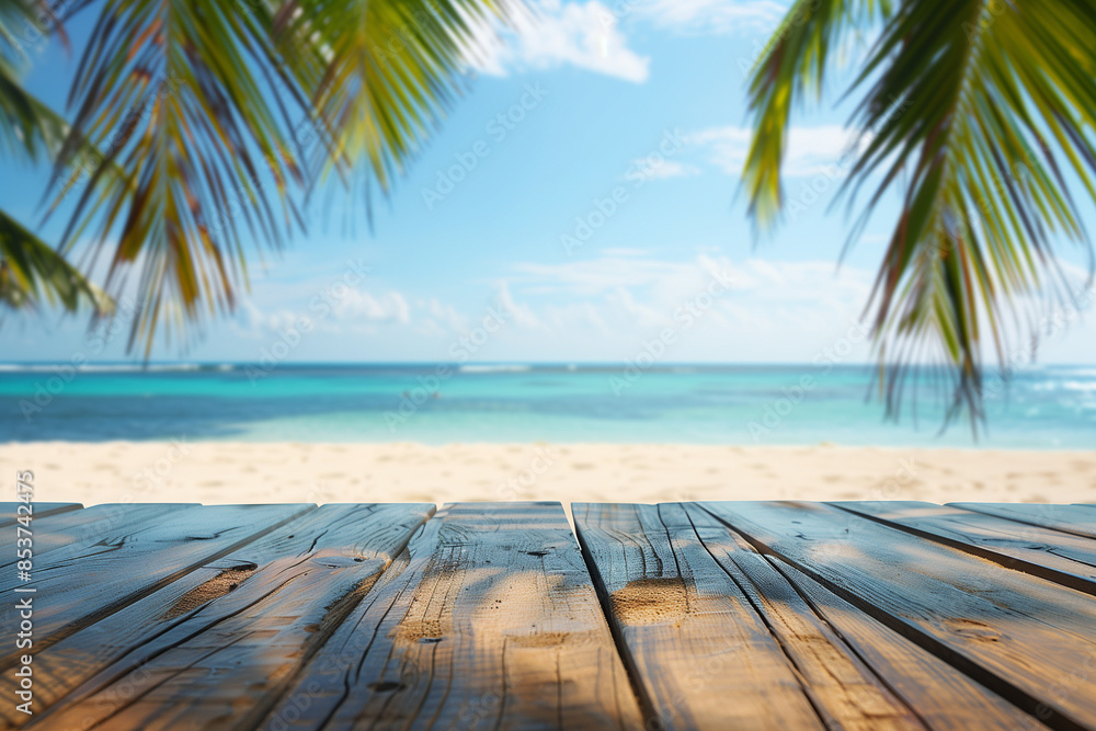 polished wooden table or platform with a smooth horizontal texture in the lower foreground, with a blurred tropical beach scene, including palm tree fronds on the upper left and right 