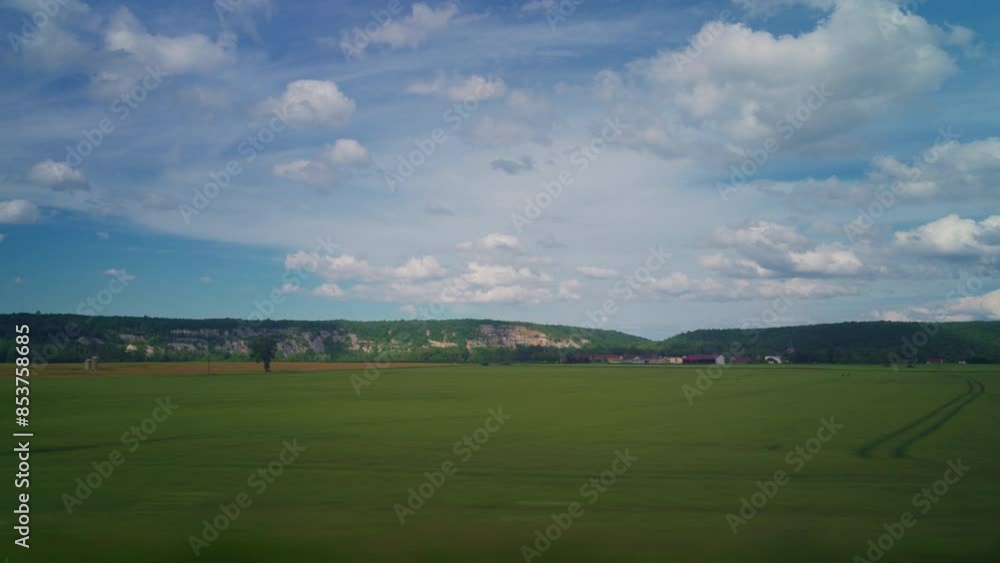 View from the window of high speed train. Beautiful trip with countryside scenery, clouds. A view of France landscape from the window of high speed train View from the window of high speed train. Beautiful trip with countryside scenery, clouds. A view of France landscape from the window of high speed train