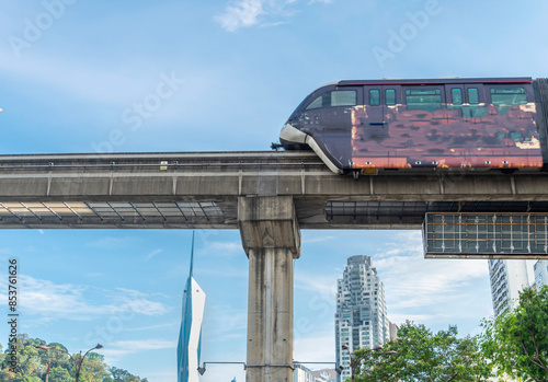 Photography An LRT train,runs along the efficient overhead railway system,high above KL city center,avoiding busy roads below,Kuala Lumpur,Malaysia